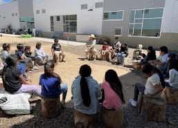 Students gather in the garden for an outdoor class
